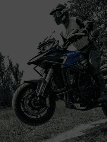 A dynamic shot of a motorcycle racer in full gear leaning into a sharp turn on a racetrack, with blurred motion effects emphasizing speed and precision.